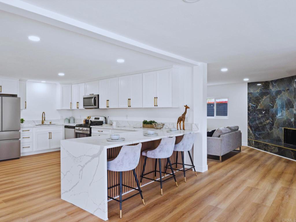 1894 Wedgemere Road El Cajon, CA 92020 - Photo 16 of 60 a living room with stainless steel appliances furniture a dining table and kitchen view