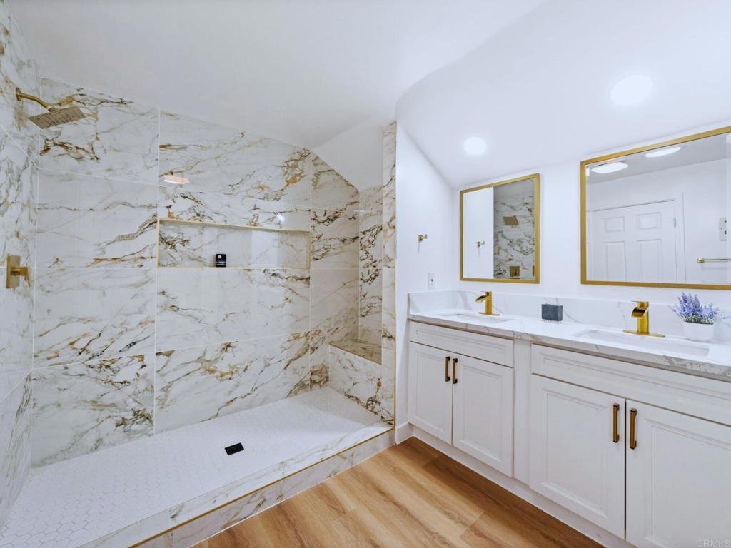 1894 Wedgemere Road El Cajon, CA 92020 - Photo 24 of 60 a spacious bathroom with shower sink and mirror