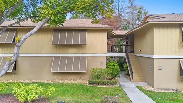 a view of a small house with a yard