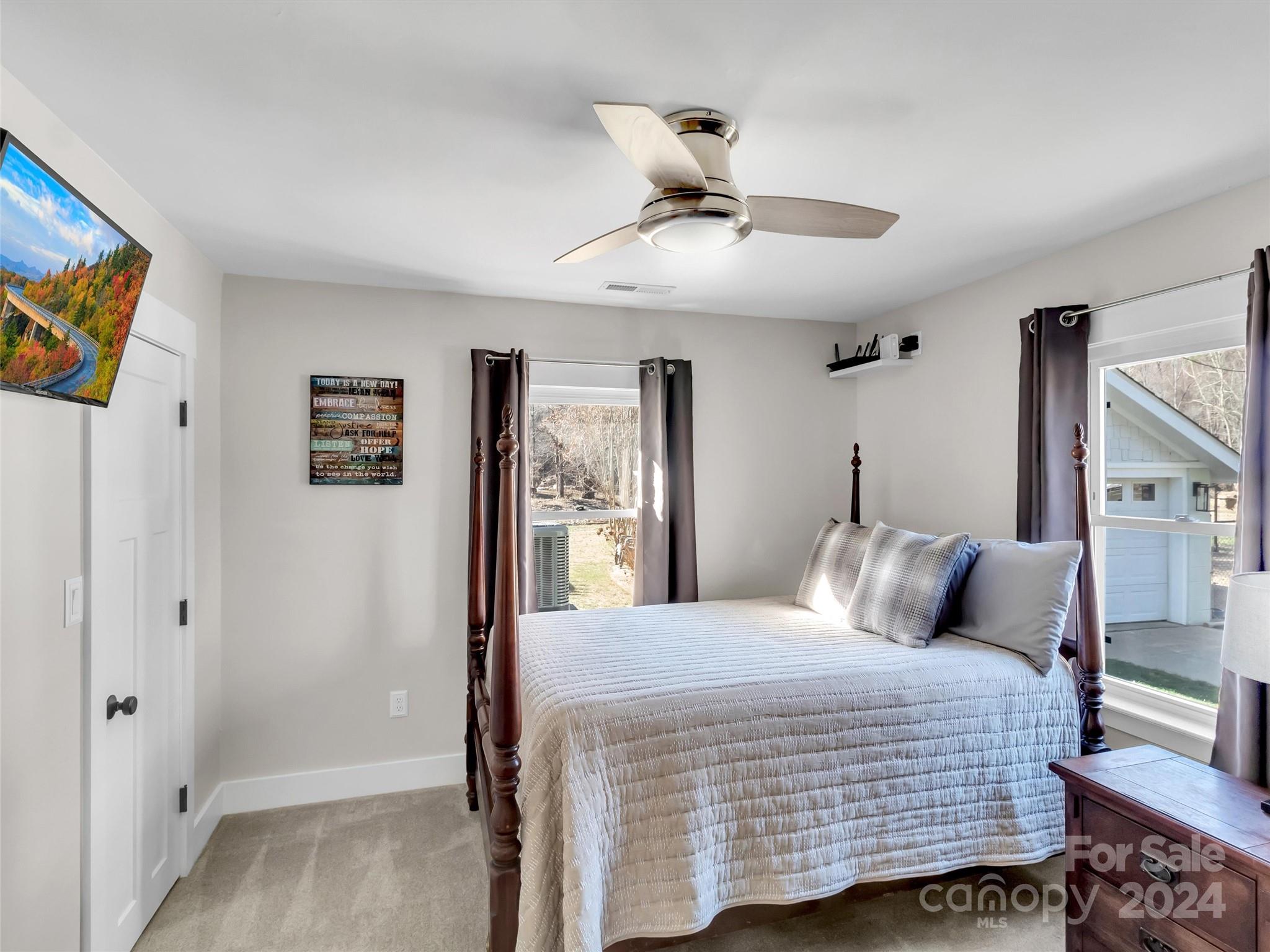 9502 Cruso Road Canton, NC 28716 - Photo 19 of 36 a bedroom with a large bed and a chandelier