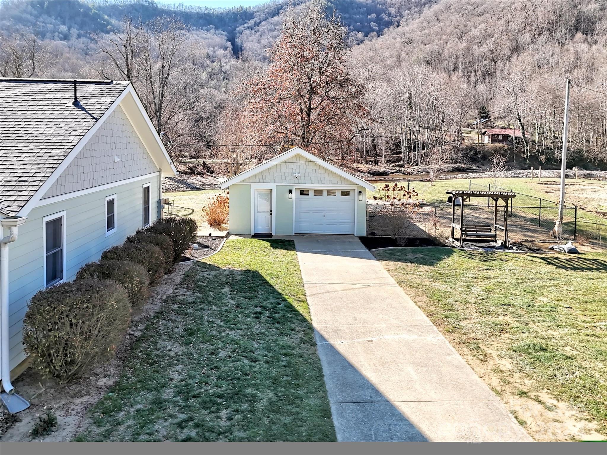 9502 Cruso Road Canton, NC 28716 - Photo 25 of 36 a front view of a house with a yard and garage