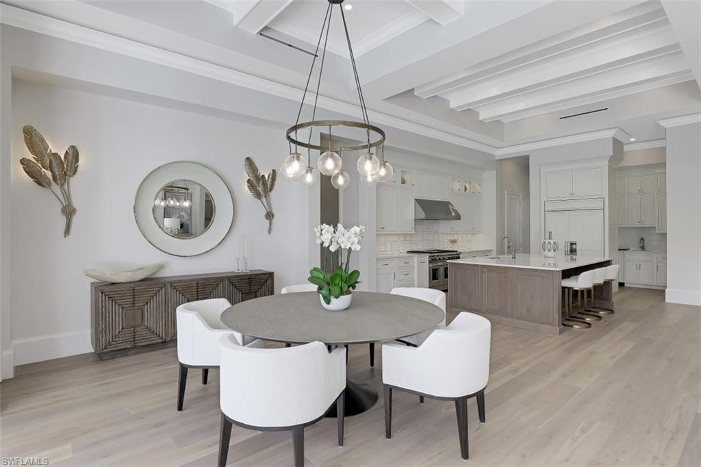 650 Wedge Drive Naples, FL 34103 - Photo 12 of 34 a view of a dining room with furniture and a chandelier