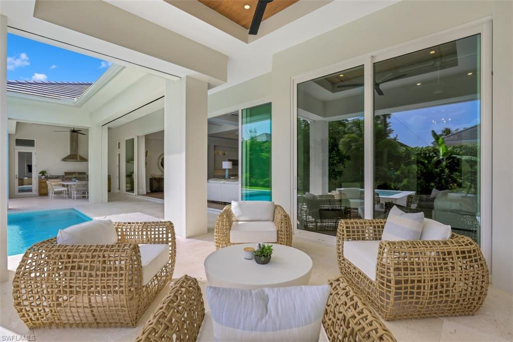 650 Wedge Drive Naples, FL 34103 - Photo 14 of 34 a living room with furniture and a potted plant