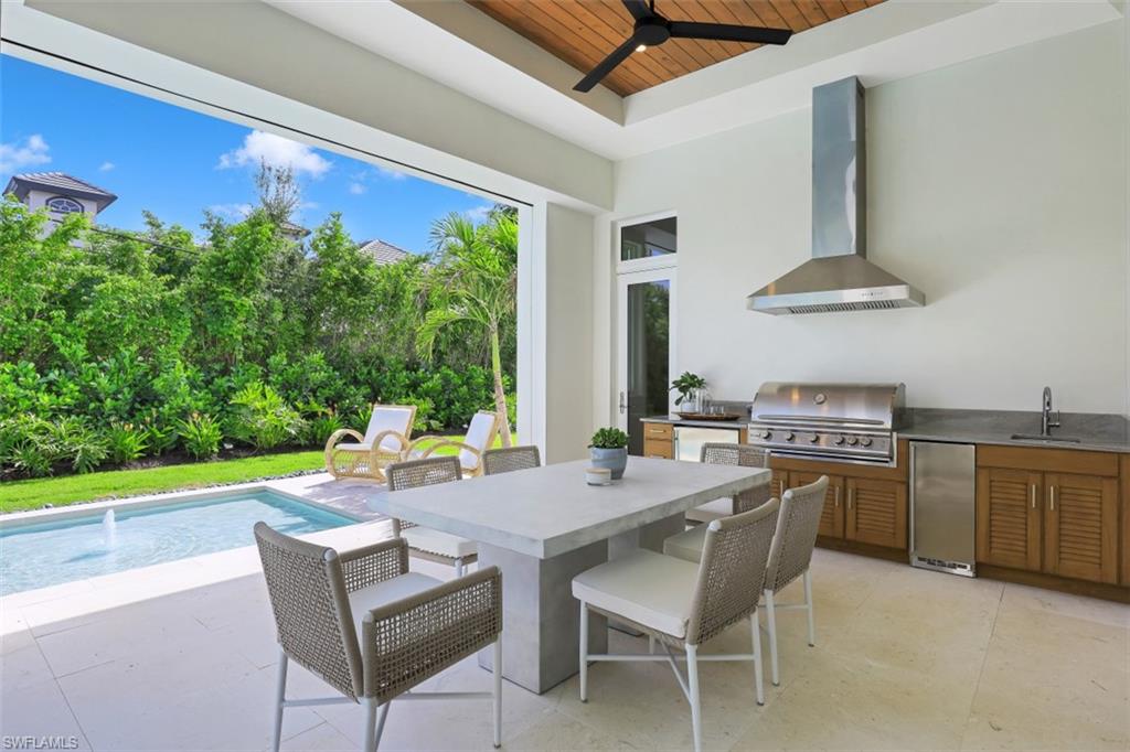650 Wedge Drive Naples, FL 34103 - Photo 16 of 34 a view of an outside dining space with furniture window and outside view