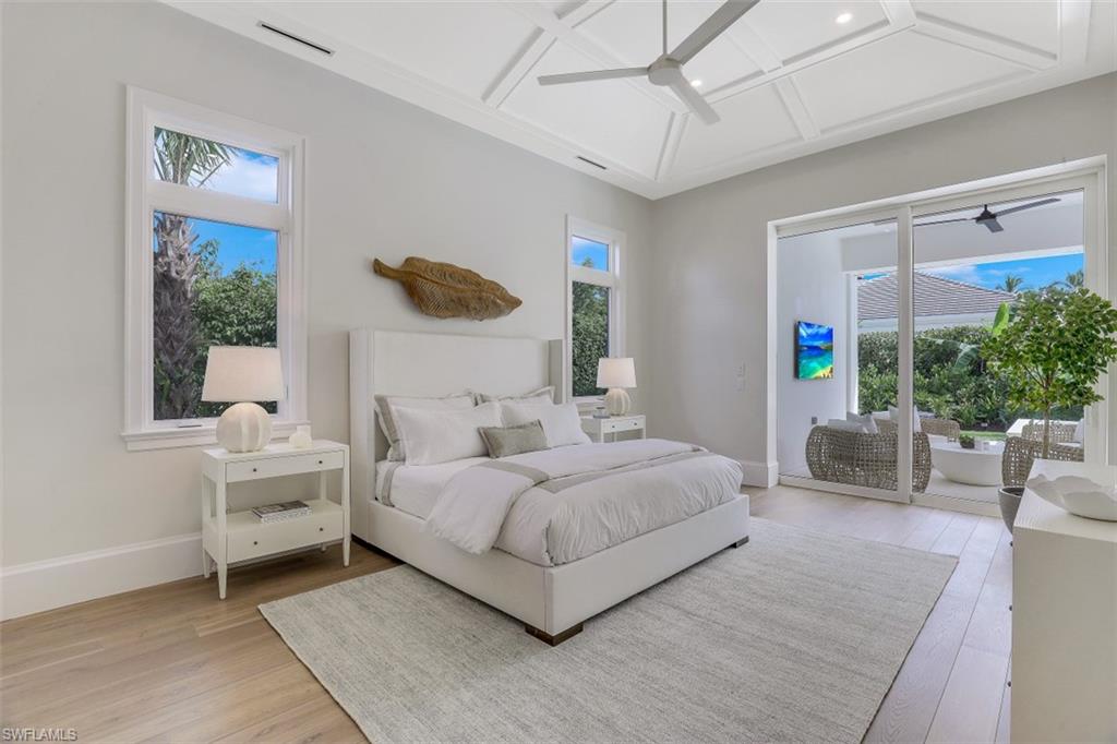 650 Wedge Drive Naples, FL 34103 - Photo 17 of 34 a bedroom with a large bed and a window