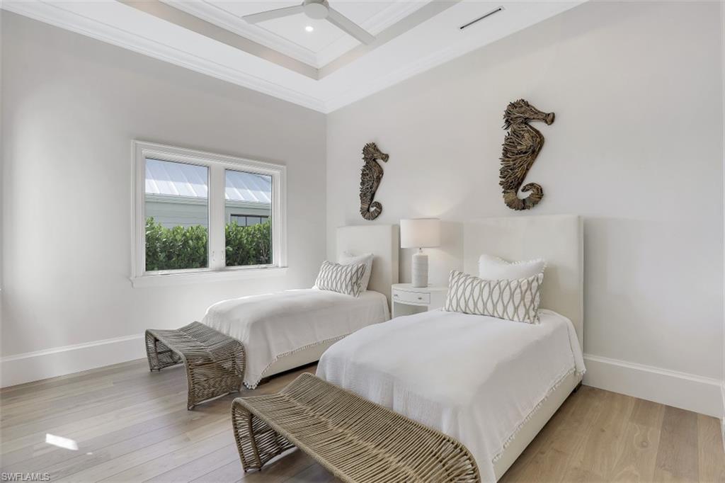 650 Wedge Drive Naples, FL 34103 - Photo 24 of 34 a bedroom with two beds and windows