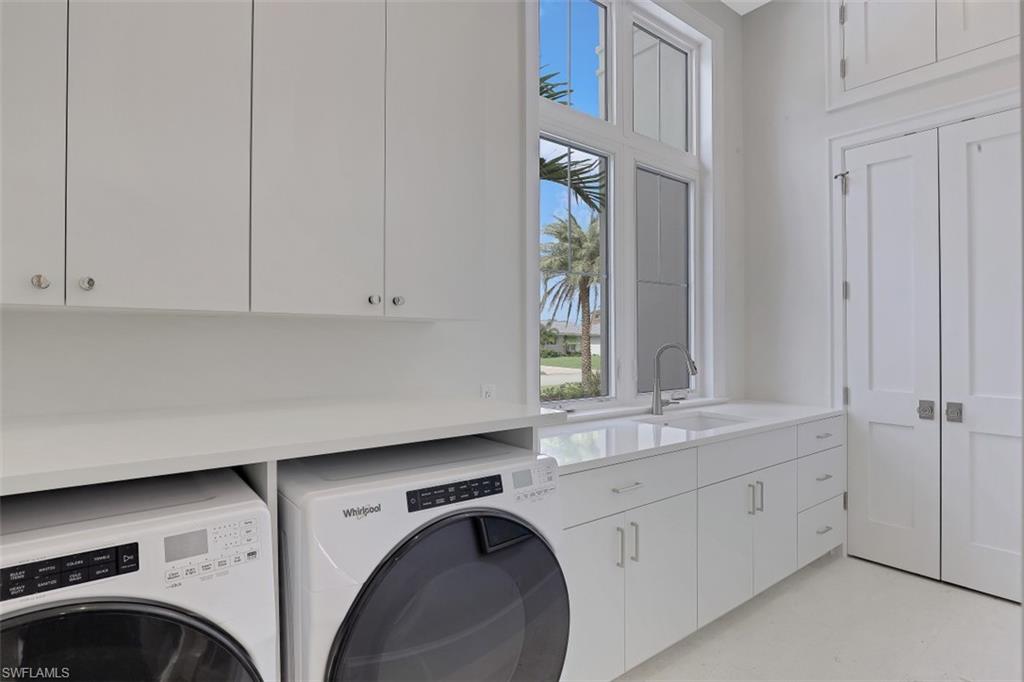650 Wedge Drive Naples, FL 34103 - Photo 28 of 34 a utility room with cabinets