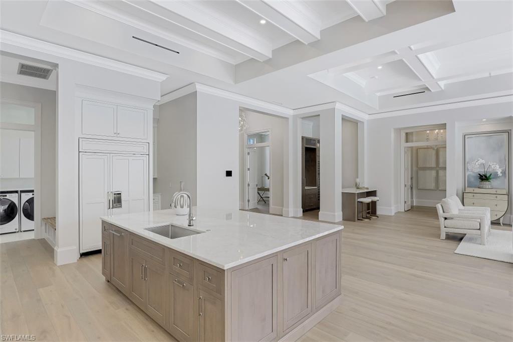 650 Wedge Drive Naples, FL 34103 - Photo 7 of 34 a large white kitchen with a large window and couch