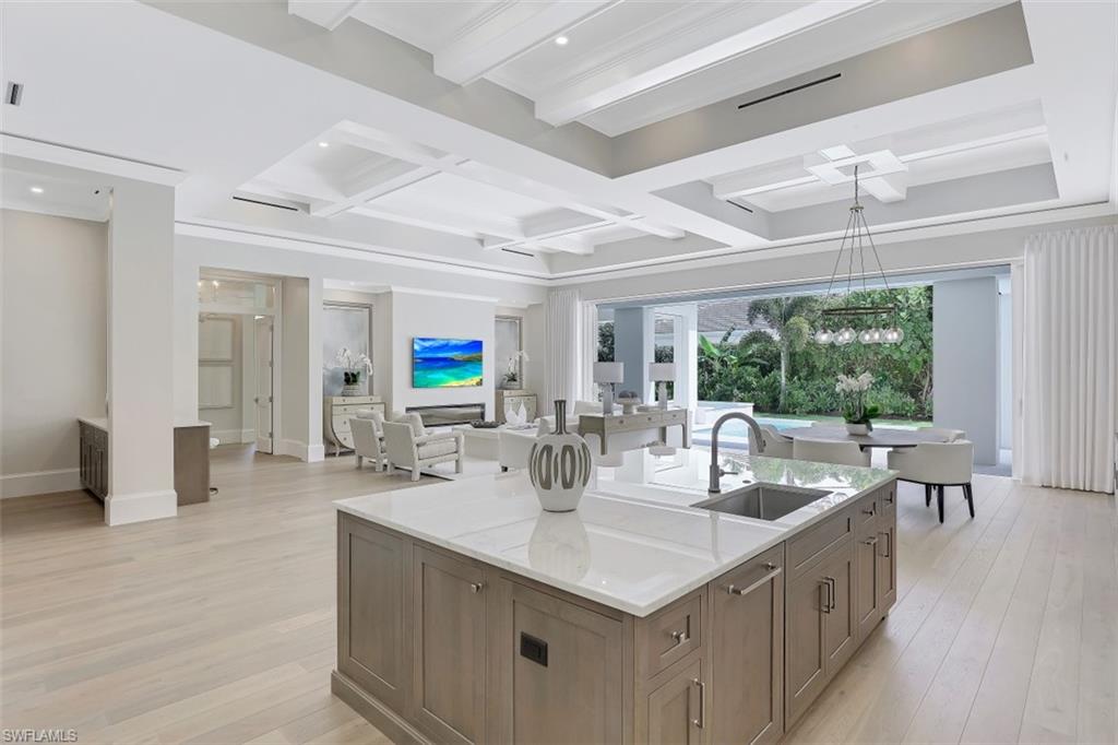 650 Wedge Drive Naples, FL 34103 - Photo 8 of 34 a kitchen with center island and living room