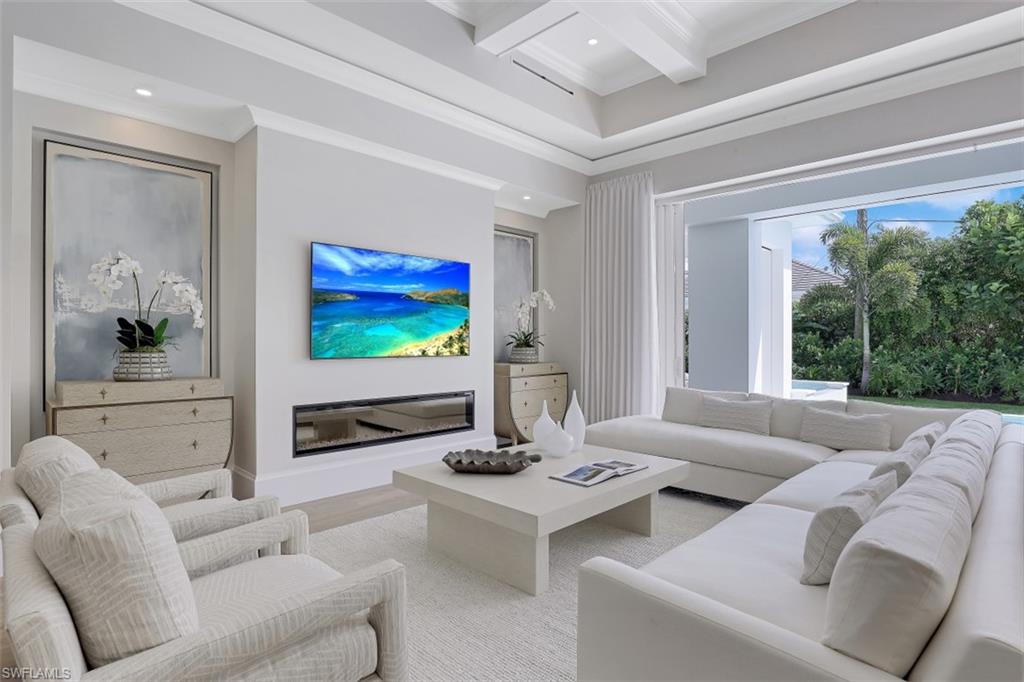650 Wedge Drive Naples, FL 34103 - Photo 9 of 34 a living room with furniture and a flat screen tv