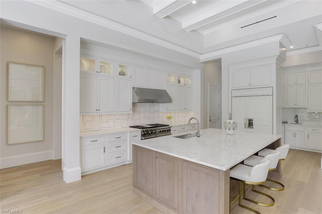 650 Wedge Drive Naples, FL 34103 - Photo 10 of 34 a kitchen with a stove a sink and a refrigerator