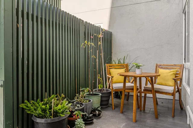 a view of a chairs and table in a backyard