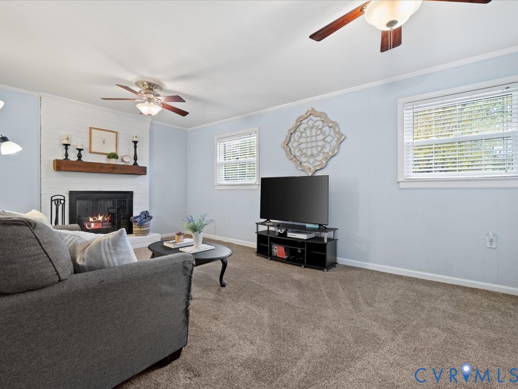 1455 Robindale Road Richmond, VA 23235 - Photo 21 of 29 a living room with furniture a fireplace and a flat screen tv