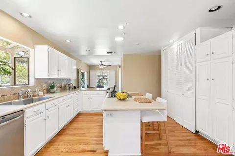 a kitchen with a sink appliances and cabinets