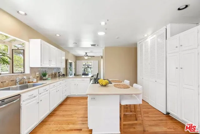 a kitchen with a sink appliances and cabinets