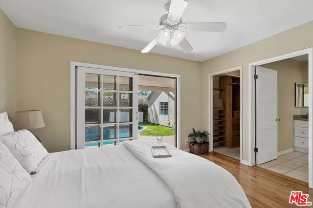 a bedroom with a bed and a large window