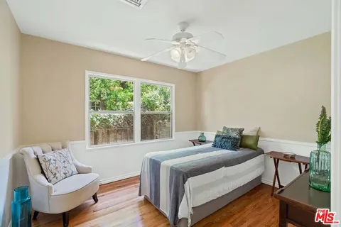 a bedroom with furniture and a large window