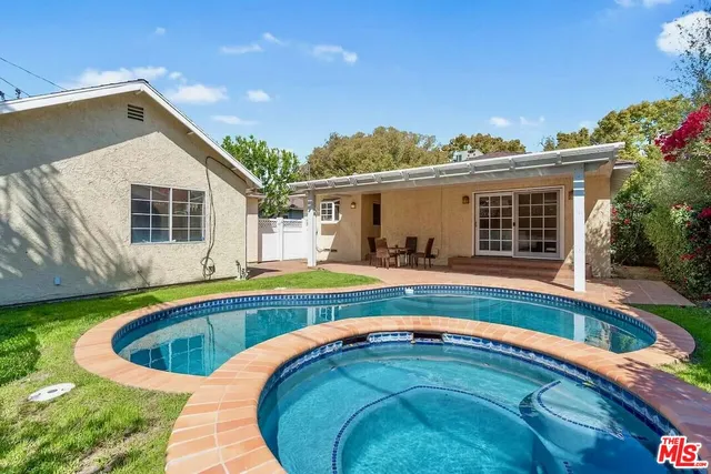 a swimming pool with outdoor seating and yard