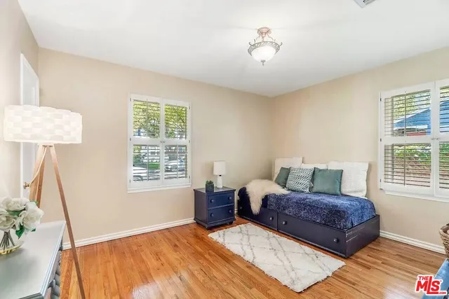 a living room with a bed furniture and a window