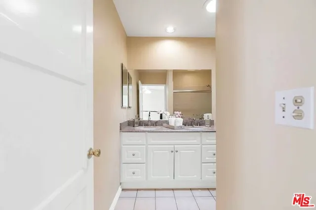 a bathroom with a granite countertop sink a toilet and a mirror