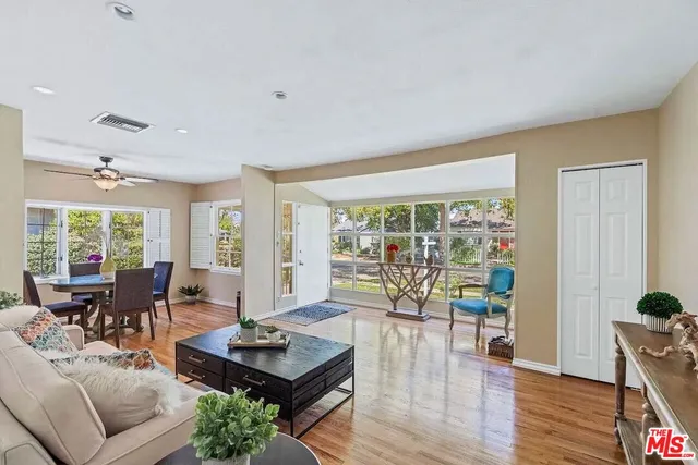 a living room with furniture and floor to ceiling windows