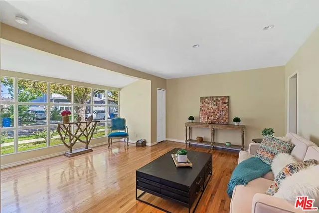 a living room with furniture and next to a window