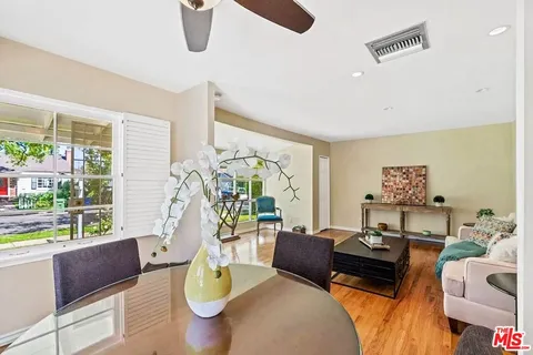 a living room with furniture and a floor to ceiling window