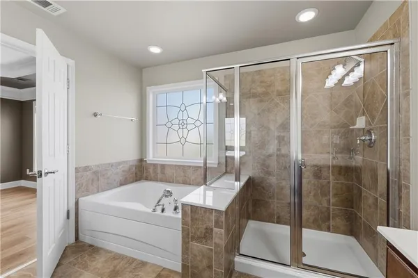 a bathroom with a bathtub and a shower