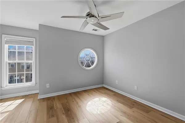 a view of a room with wooden floor and windows