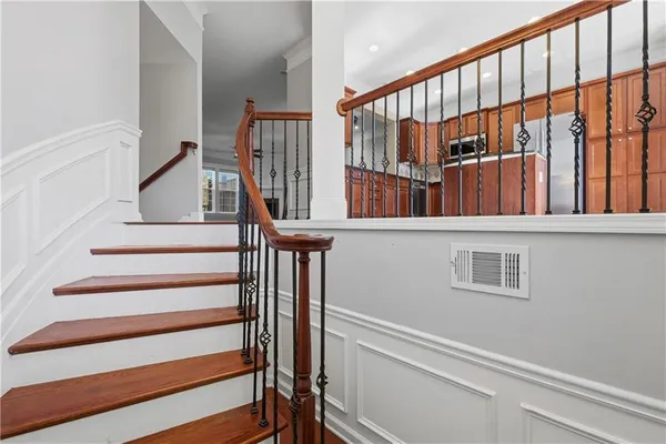 a view of staircase with wooden floor and a window