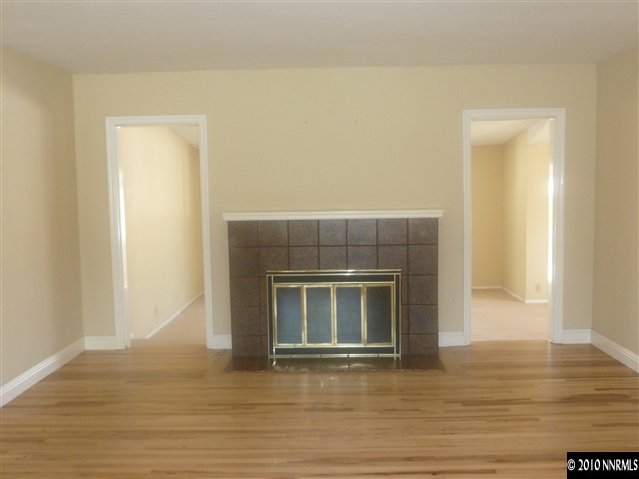 1135 Mt Rose Street Reno, NV 89509 - Photo 2 of 7 a view of an empty room with wooden floor and a window