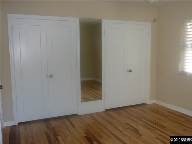 1135 Mt Rose Street Reno, NV 89509 - Photo 5 of 7 a view of an empty room with wooden floor and a window