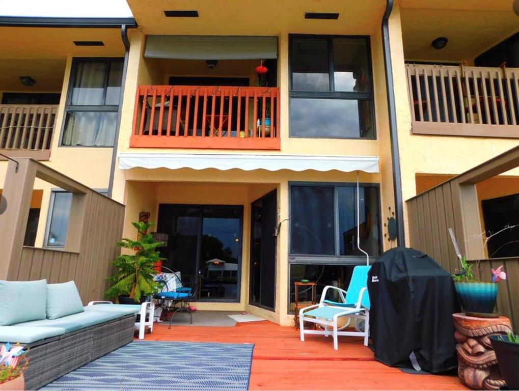 a view of living room and deck with furniture