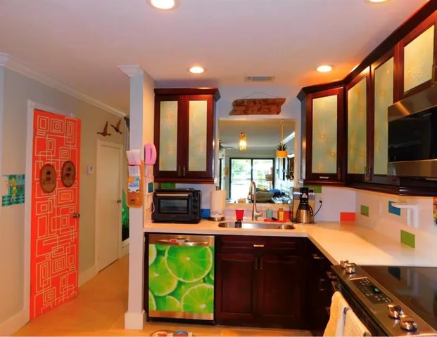 a kitchen with stainless steel appliances a sink stove and cabinets
