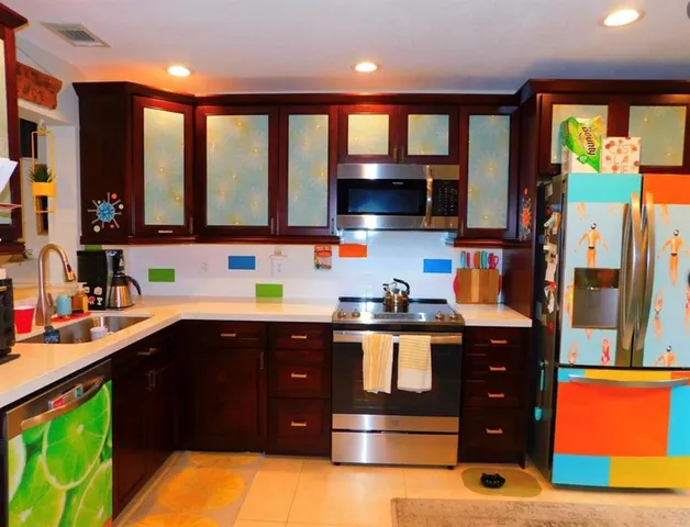 a kitchen with stainless steel appliances kitchen island granite countertop a sink stove and cabinets