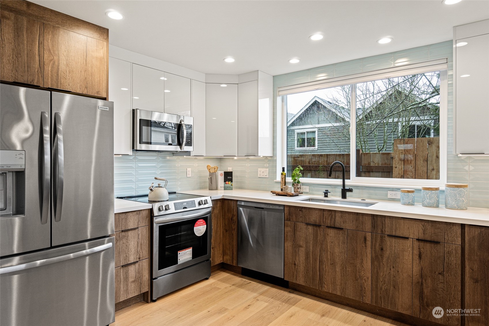 4256 33rd Avenue West Seattle, WA 98199 - Photo 11 of 24 a kitchen with a sink stainless steel appliances and window