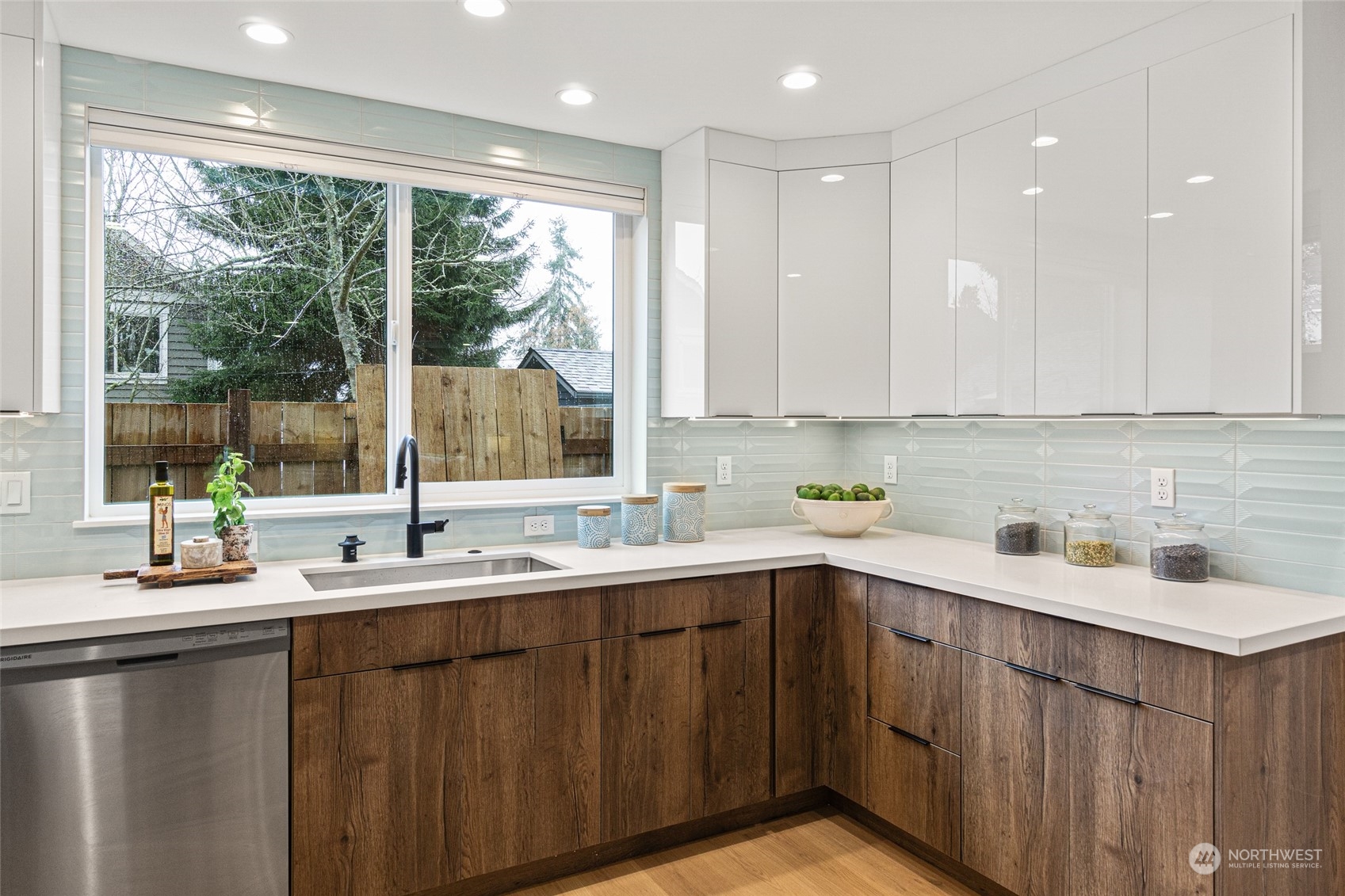 4256 33rd Avenue West Seattle, WA 98199 - Photo 12 of 24 a kitchen with a sink stove and cabinets