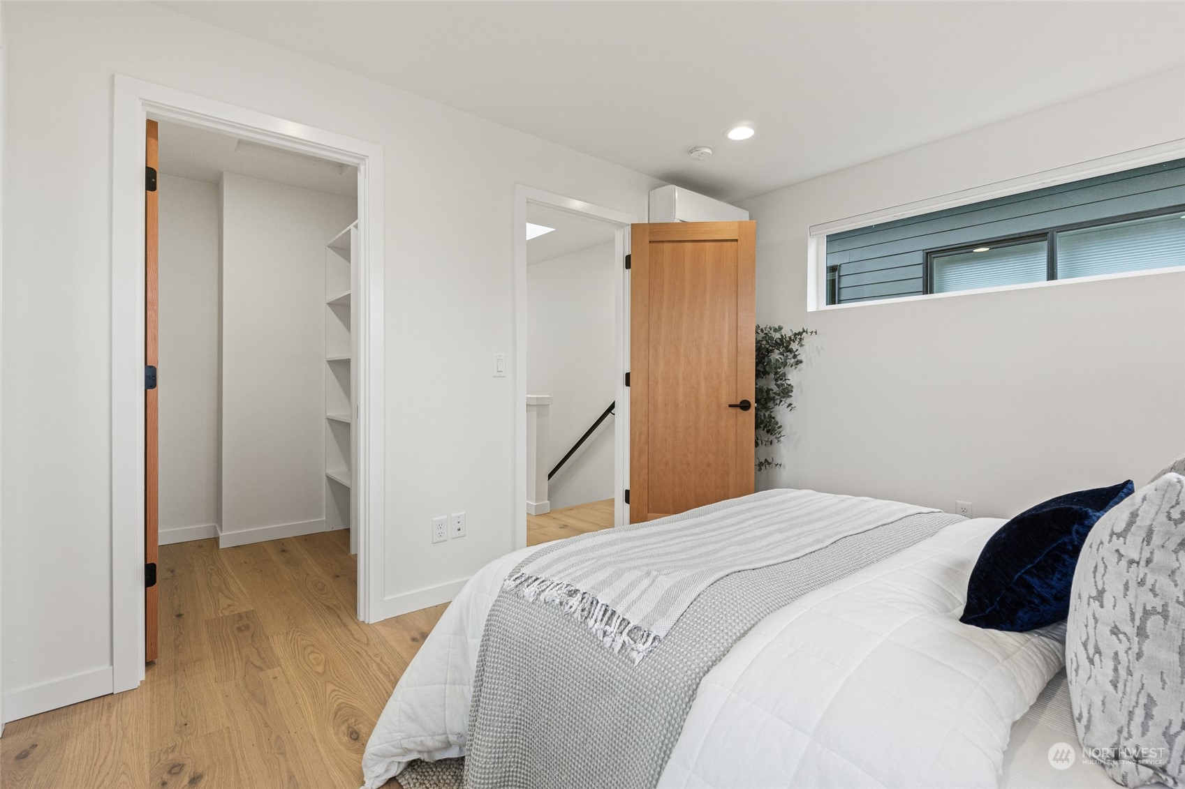 4256 33rd Avenue West Seattle, WA 98199 - Photo 14 of 24 a bedroom with a bed and wooden floor