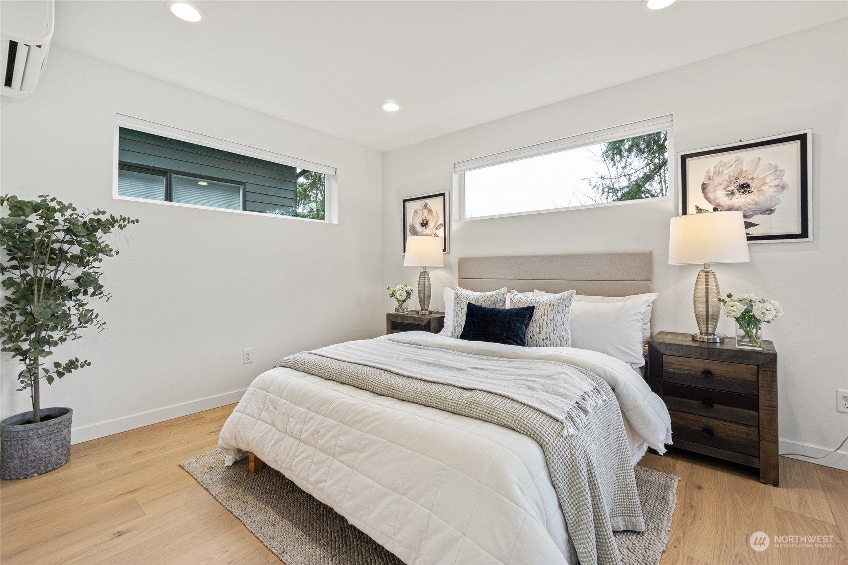 4256 33rd Avenue West Seattle, WA 98199 - Photo 17 of 24 a bed room with a bed and a potted plant