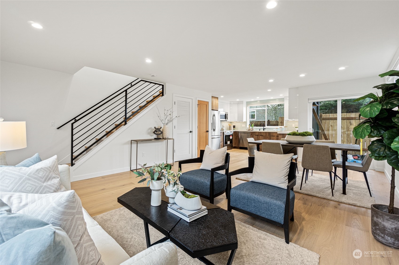 4256 33rd Avenue West Seattle, WA 98199 - Photo 4 of 24 a living room with furniture kitchen view and a wooden floor