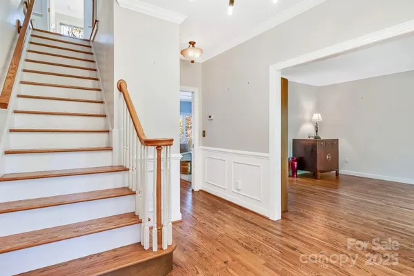 a view of entryway and hall with wooden floor