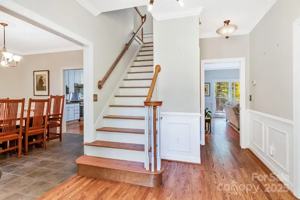 a view of entryway and hall with wooden floor
