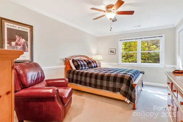 a bedroom with a bed couch and window