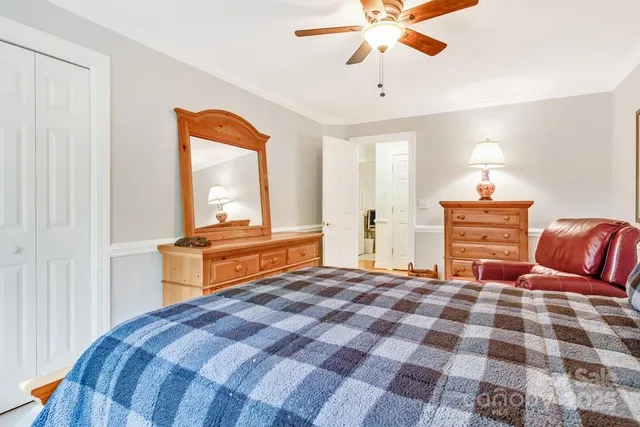 a bedroom with a bed and a chandelier