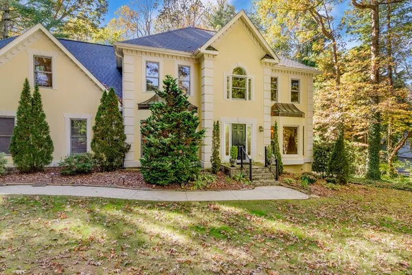 a front view of a house with garden