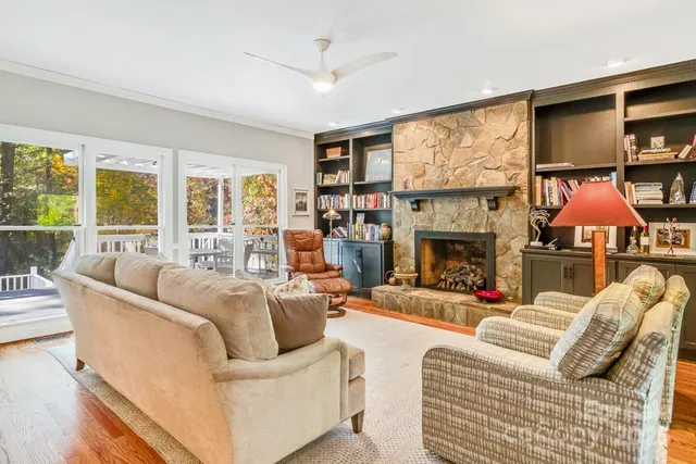 a living room with furniture a fireplace and a flat screen tv
