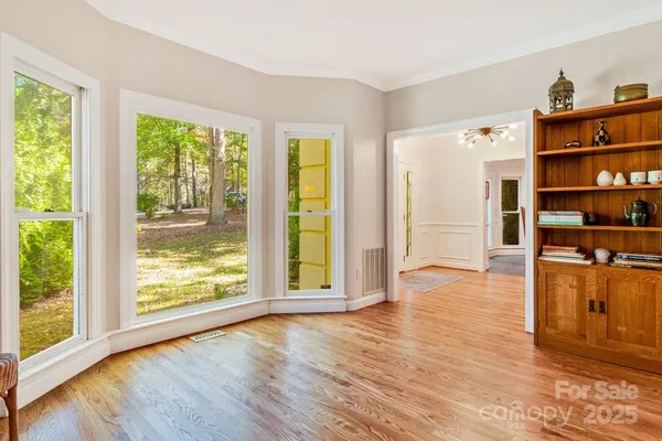 a view of a living room with furniture and wooden floor