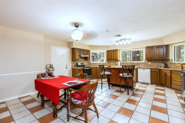 a view of a dining room with furniture and wooden floor