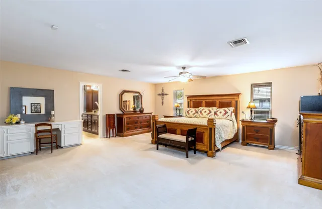 a bedroom with furniture and a lamp