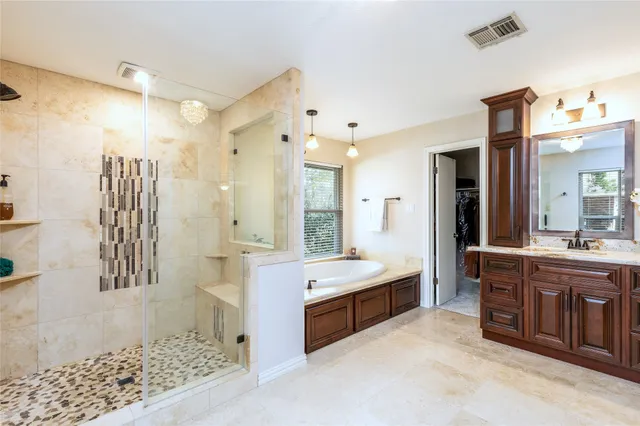 a large bathroom with a double vanity sink a large mirror and shower